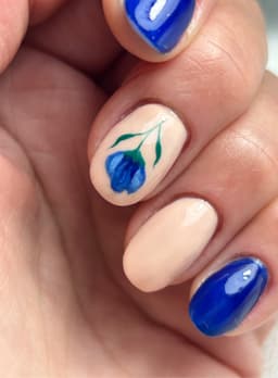Gel manicure with hand painted detail 💙