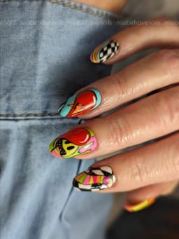 Long nails with bold pop art designs in bright colours, featuring graphic patterns and comic-style details – a creative set by MissbehaveNails in Leighton Buzzard.