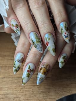 Long stiletto nails with intricate festive designs featuring holly, berries, and winter details – a bespoke seasonal set created at MissbehaveNails in Leighton Buzzard.