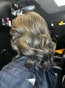 Soft balayage with golden highlights styled at Rhubarb Hair, Beauty & Barbers in Stockton-on-Tees – natural waves with a glossy finish.